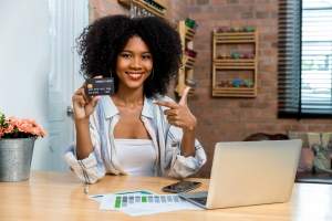 young-woman-consumer-holding-credit-card-and-smart-2023-11-27-05-13-52-utc (1)