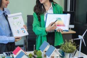 two-businesswomen-sit-at-a-table-in-the-office-dis-2024-12-20-17-51-10-utc (1)